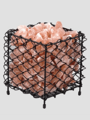 Industrial black wire mesh cube basket filled with premium Himalayan pink salt chunks from Suhail Salt, a leading manufacturer and exporter.