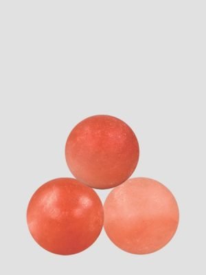 Set of three polished Himalayan pink salt massage balls in various shades of orange and pink, manufactured by Suhail Salt, a leading pink salt exporter and wellness product supplier.