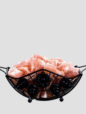 "Premium pink Himalayan salt chunks in decorative black wire basket - Suhail Salt manufacturer"